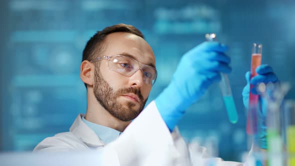 Male Scientist Worker Making Pharmacology Substance Using Beaker at Digital Lights Background alt