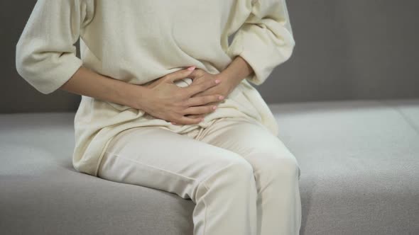 Young Woman Suffering From Strong Menstrual or Stomach Ache, Gynecology Problems alt