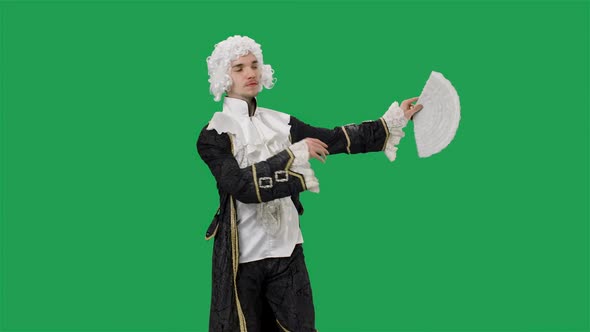 Portrait of Courtier Gentleman in Black Historical Vintage Suit and White Wig Waving a Fan and alt