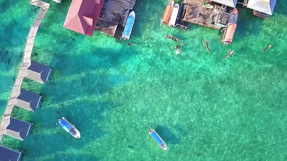 Aerial flight towards local village and bars in Malaysia, birds eye perspective moving forward in sl alt