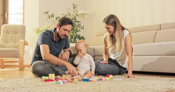 Young Loving Happy Parents Spend Their Free Day with a Child on the Carpet Building alt