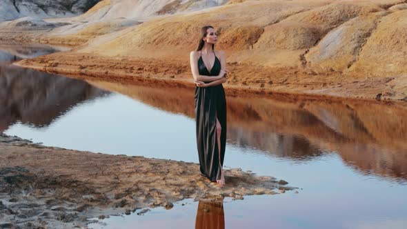 Beautiful woman posing on other-worldly hilly landscape