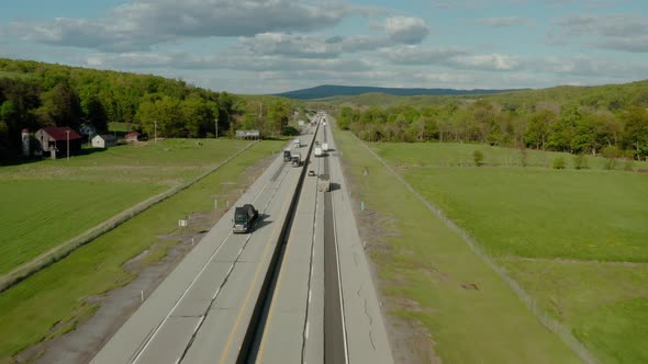 Aerial Drone View of Flight Over the Highway with Many Cars and Trucks alt