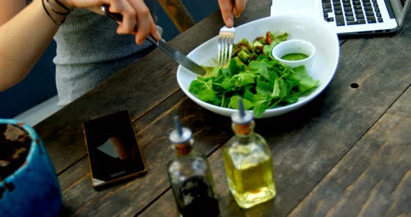 Young Woman Having Salad on The Table 4k alt