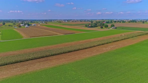 Aerial View of Rural America of Amish Farmlands With Amish Harvesting the Crops alt