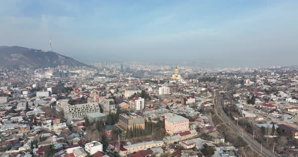 Aerial view of Holy Trinity Cathedral Sameba in Tbilisi Georgia. Sunrise drone footage. alt
