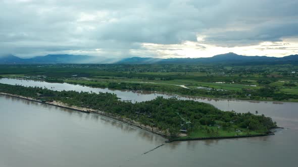 The beautiful green shoreline of the Beach in the Fiji Islands on cloudy day - aerial alt