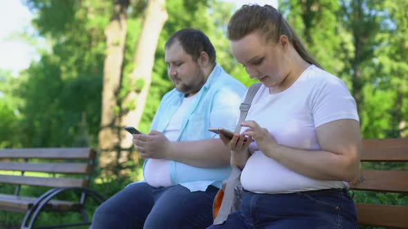 Obese Couple Posting Photos in Social Network, Upset Girl Waiting for Likes alt
