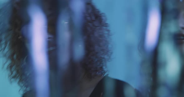 Two girl dance winking behind a glitter curtain alt