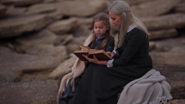 Woman Reading a Book By the Girl on the Coast in the Evening Slow Motion