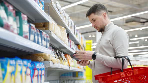 Shopping in Grocery Man is Buying Healthy Food for Proper Nutrition alt