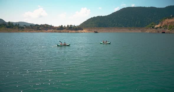 Two couples kayaking in Zaovine lake in Tara mountain region in Serbia