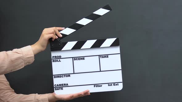 Female Hands With Clapper on Blackboard Background, Successful Career, Startup alt