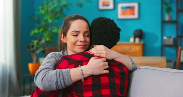 Close Up of Happy Lovely Beloved Coupe Young Man and Beautiful Woman Hugging Together Sitting alt