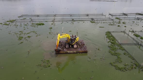 aerial view of crane in traditional floating fish pond on swamp in Indonesia alt