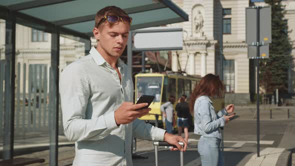 The Man is Texting on His Smartphone alt