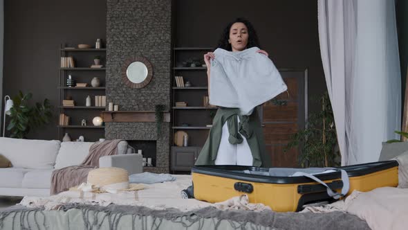 Young Funny Happy Woman Folds Clothes Packs Suitcase Going on Journey Feels Joy in Anticipation Trip alt