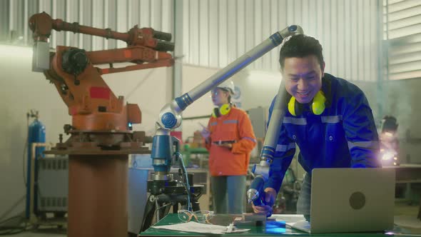 asian male engineer specialist with Measuring machine with a manipulator arm
