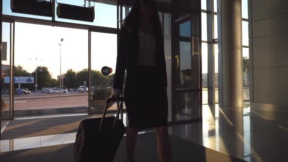 Business Lady Going to the Airport with Her Luggage alt