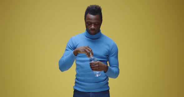 Man Opening a Bottle and Drinking alt