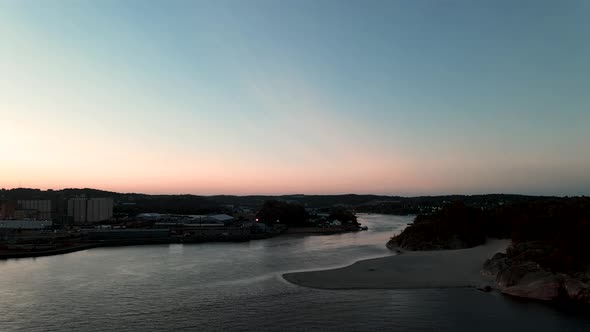 The river Logen pouring into the ocean in Larvik Norway during a beautiful sunset alt