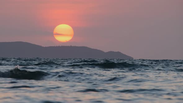 Beautiful pink sunset over blue sea alt
