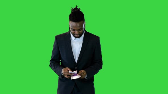 Black Man in Office Suit Walk Counting Money on a Green Screen Chroma Key alt
