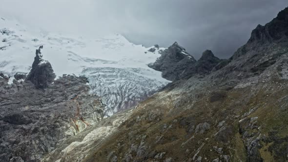 Flight along the Peru Andes mountains with a view of melting glaciers caused by global warming alt