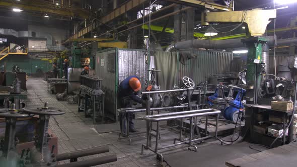 Production Workers Doing Their Job at the Factory Environment Examining Production Sparks From the alt