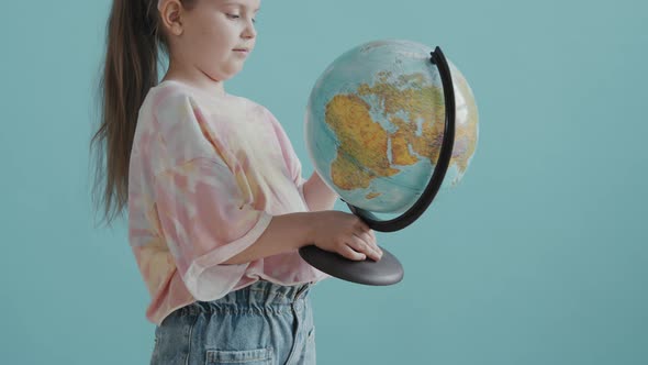 Portrait of Girl with World Globe alt