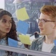 Creative Millennials Arranging Sticky Notes on Glass Wall in Office - VideoHive Item for Sale