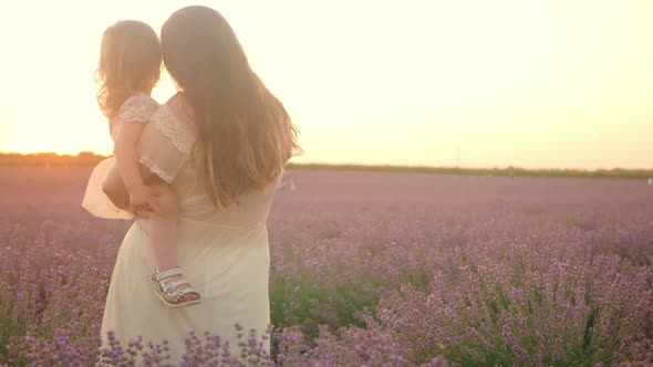 Mother and Daughter in a Lavender Field at Sunset alt