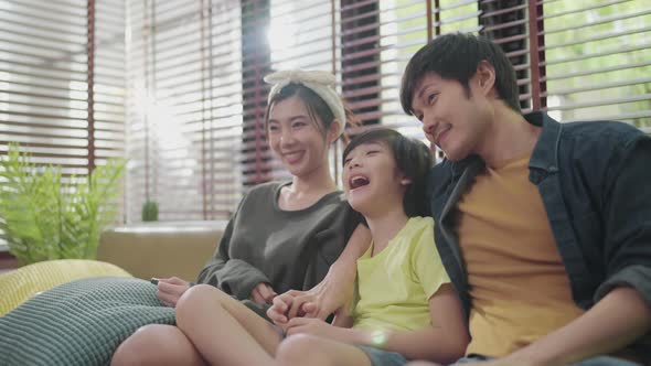 Portrait of Asian sweet family  sitting and smiling in living room
