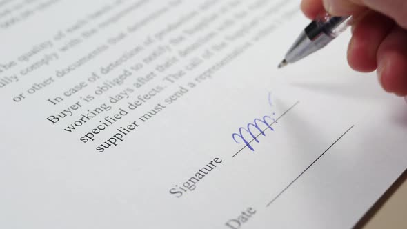 The Hand of a Business Person Signs a Document, a Contract. The Concept of Business Transactions. alt