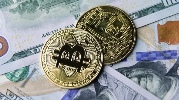 Bitcoin BTC coin rotate on 100 dollars USD bills. blockchain, mining GPU alt