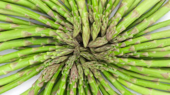 Green asparagus on a light table, rotation. Fresh and tasty organic asparagus alt