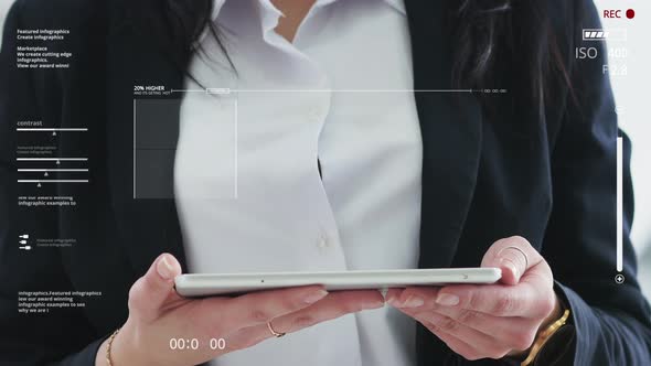 Screen with Graphic Elements. Close-up Girl in a Suit Holds a Tablet and Presses on It with a Finger