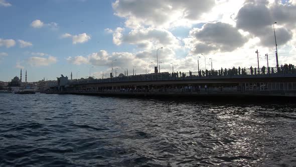 istanbul Karakoy District Galata Bridge cloudy day at sunset alt