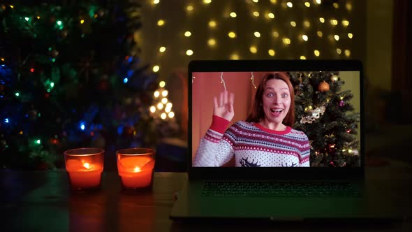 Smiling Woman on a Videocall She is Happy and Wishing a Merry Christmas Online