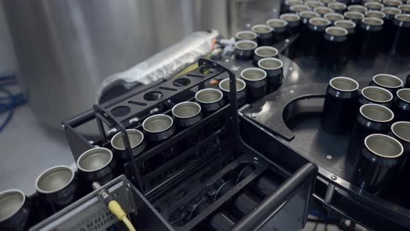 Empty Cans On Conveyor For Filling Of Beer In Factory alt