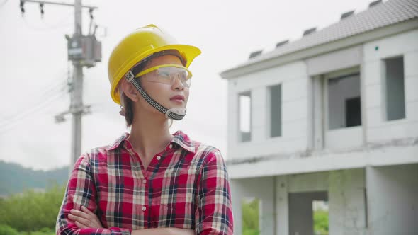 Portrait of asian engineer woman at construction site. Construction, Engineer, Architecture concept. alt