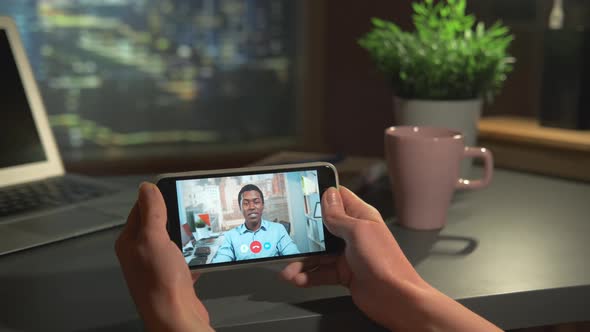 Horizontal Smartphone Screen with Video Calling to the Black Businessman at Office alt