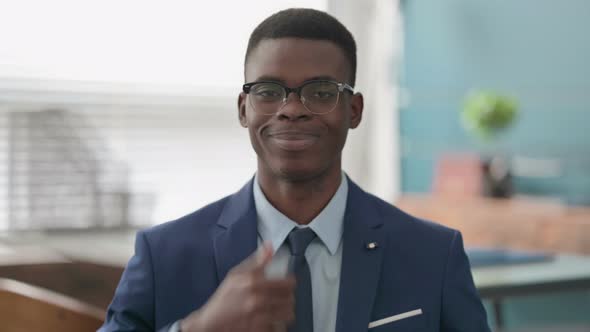 Young African Businessman Showing Thumbs Up Sign alt