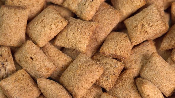 Crispy chocolate pads rotation in macro. Cocoa cereal dessert for a fast breakfast. Morning alt