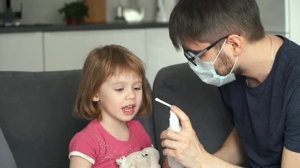 Father Sanitizes Mouth Daughter with Disinfecting Antiseptic Spray