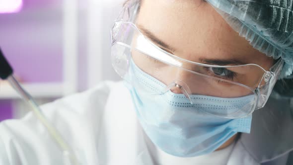 Medical Scientist Inspecting Microgreens Wearing Protective Unform Working in Laboratory alt