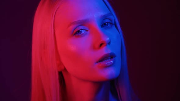 Portrait of a Young Woman in Neon Light alt