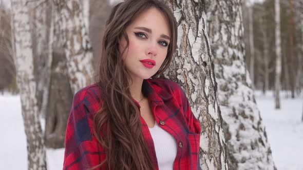 Woman with Red Lips in Winter Forest