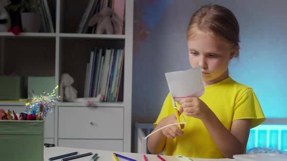 Child with Scissors Makes Crafts