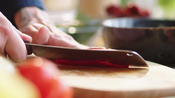 Male Hands Cutting Red Hot Pepper and Removing Pulp alt